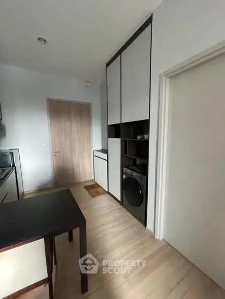 Modern kitchen with sleek cabinetry and built-in washing machine