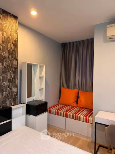 Cozy bedroom with modern decor and built-in seating area, perfect for relaxation.