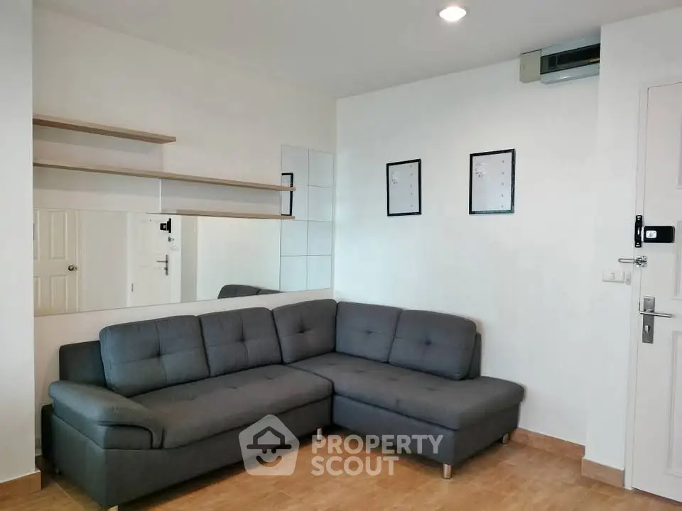Modern living room with stylish gray sofa and minimalist decor
