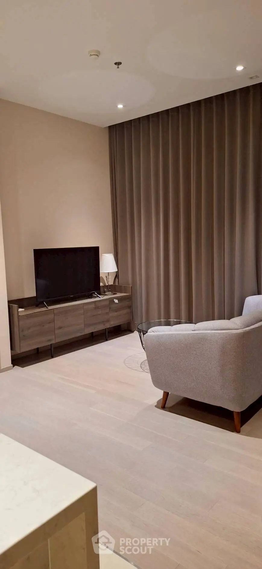 Modern living room with stylish furniture and large TV, perfect for relaxation and entertainment.
