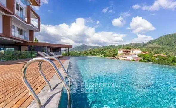 Luxurious infinity pool with stunning mountain views at modern apartment complex.