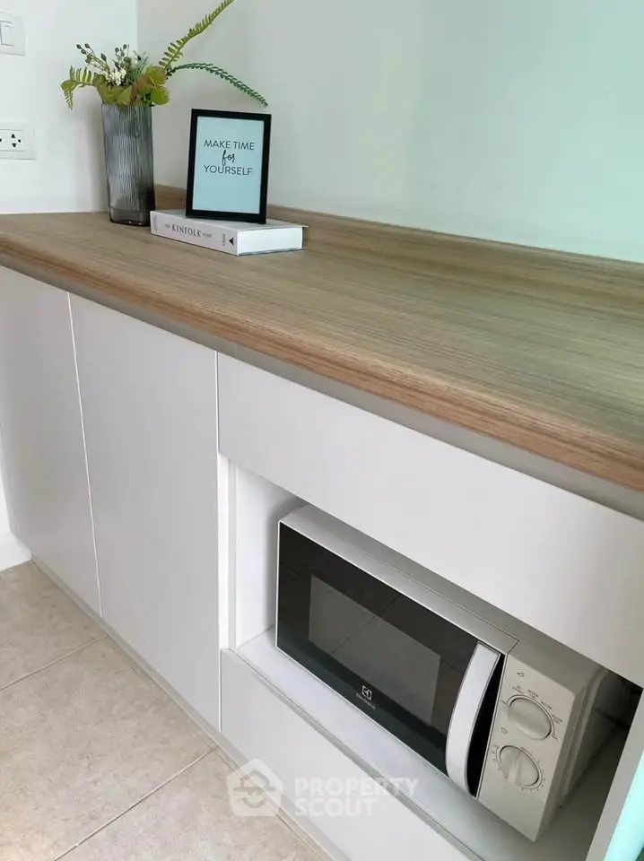 Modern kitchen with sleek cabinetry and built-in microwave, perfect for contemporary living.