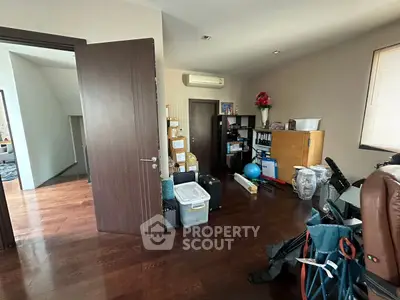 Spacious home office with wooden flooring and ample storage space