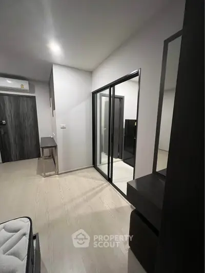 Modern apartment interior with sleek design and mirrored closet doors
