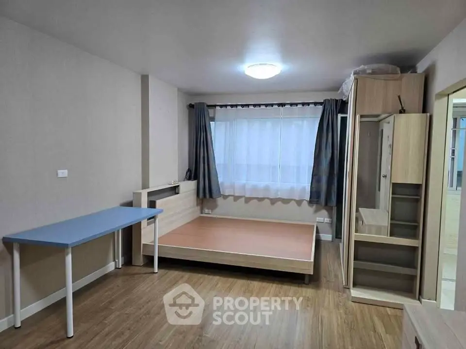 Spacious bedroom with modern furnishings and ample natural light