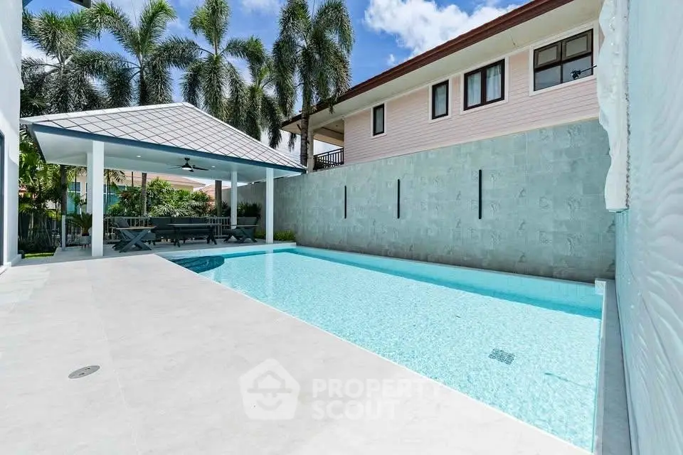 Luxurious outdoor pool area with modern design and shaded seating, perfect for relaxation and entertainment.