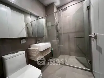 Modern bathroom with glass shower and sleek fixtures