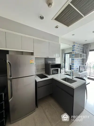 Modern kitchen with sleek appliances and open layout in a stylish apartment