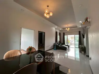 Spacious modern living room with elegant lighting and balcony access