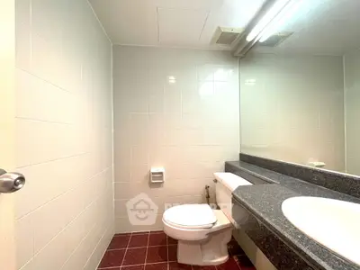 Spacious bathroom with modern fixtures and large mirror