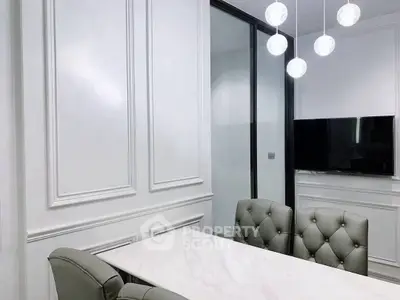 Elegant dining area with modern lighting and wall paneling