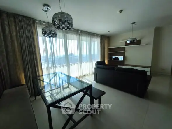 Spacious living room with modern furniture and large windows offering stunning views.