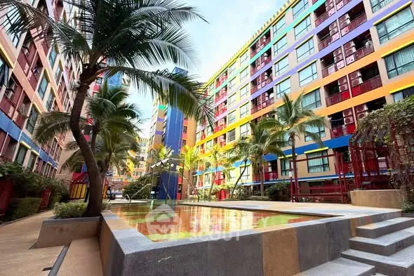 Vibrant apartment complex with colorful facade and palm trees