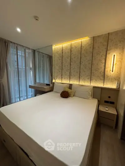 Luxurious bedroom with elegant lighting and modern decor, featuring a comfortable bed and stylish curtains.