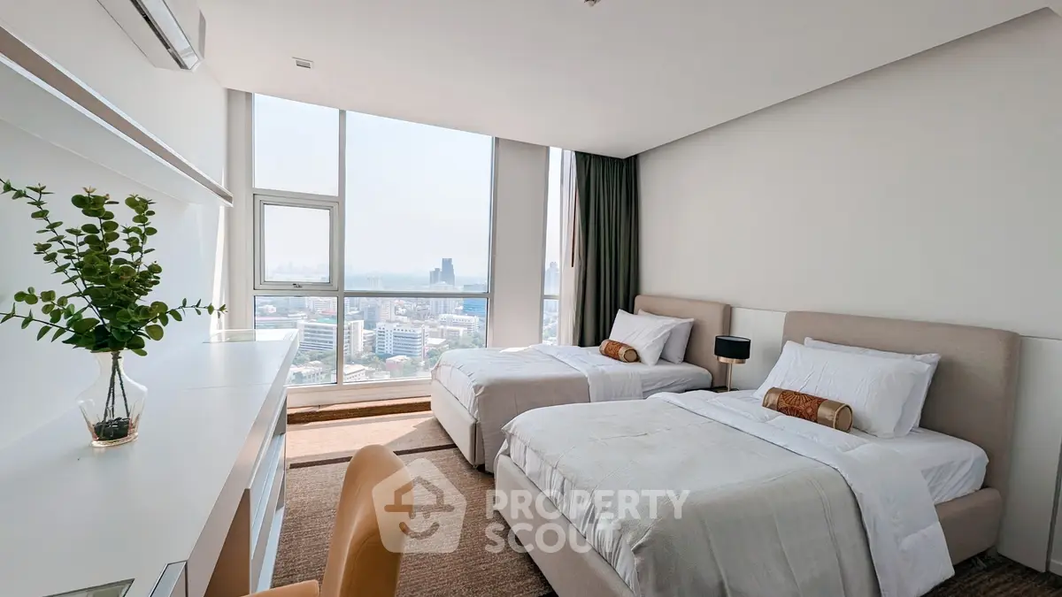 Spacious bedroom with twin beds and stunning city view, perfect for urban living.