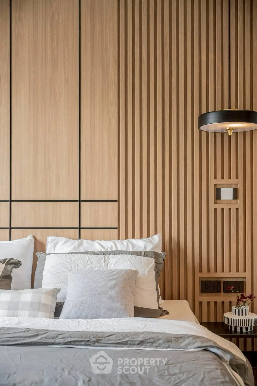 Modern bedroom with stylish wood paneling and elegant lighting