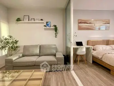 Modern studio apartment with cozy living area and stylish bedroom, featuring elegant decor and natural light.