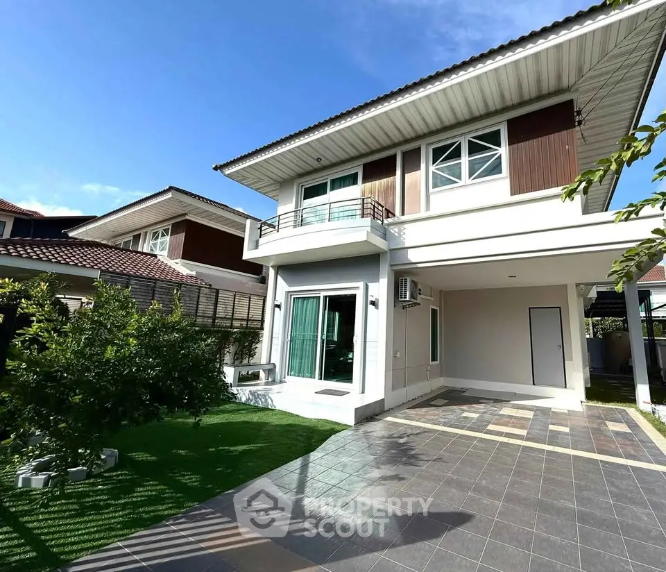 Modern two-story house with spacious driveway and lush garden