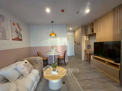 Stylish modern living room with cozy sofa, chic decor, and elegant dining area in open layout.