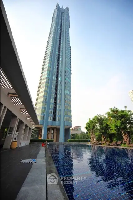 Stunning high-rise building with luxurious pool and modern architecture.