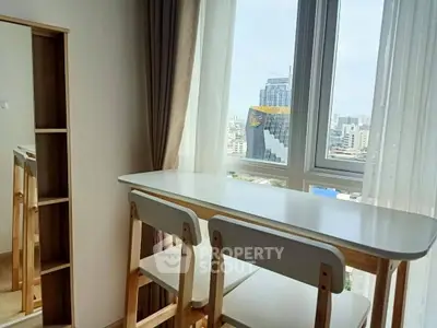 Modern apartment with city view and stylish dining area near window.