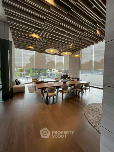 Luxurious dining area with modern decor and large windows offering natural light.