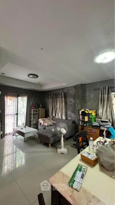 Spacious living room with modern decor and large windows for natural light.
