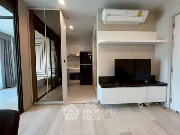 Modern living room with sleek design and integrated kitchen area