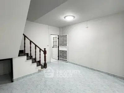 Spacious interior with staircase and modern tiled flooring, ideal for customization.