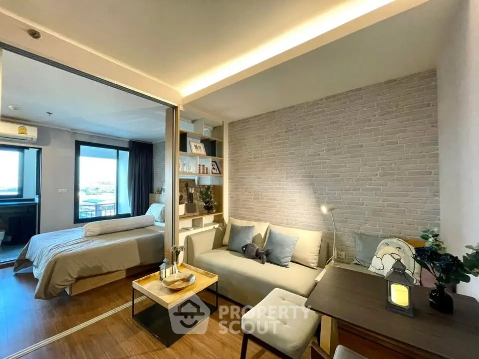 Modern studio apartment with cozy living area and stylish bedroom, featuring elegant decor and natural light.