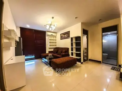 Spacious living room with modern furniture and elegant lighting in a stylish apartment.