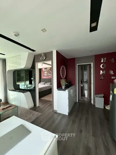 Modern apartment interior with stylish decor and open layout, featuring a cozy living area and bedroom view.