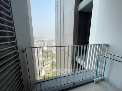 Modern apartment balcony with city view and sleek railing design.