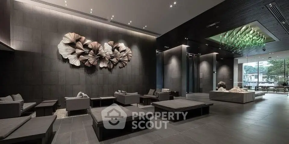 Luxurious modern lobby with artistic wall decor and plush seating in a high-end building.