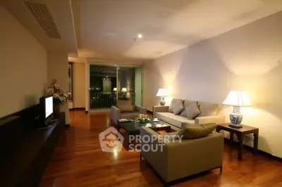 Spacious living room with elegant decor and large windows offering a stunning view.