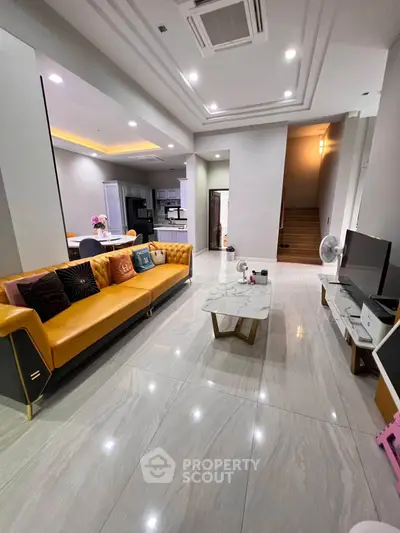 Spacious modern living room with stylish decor and open kitchen layout