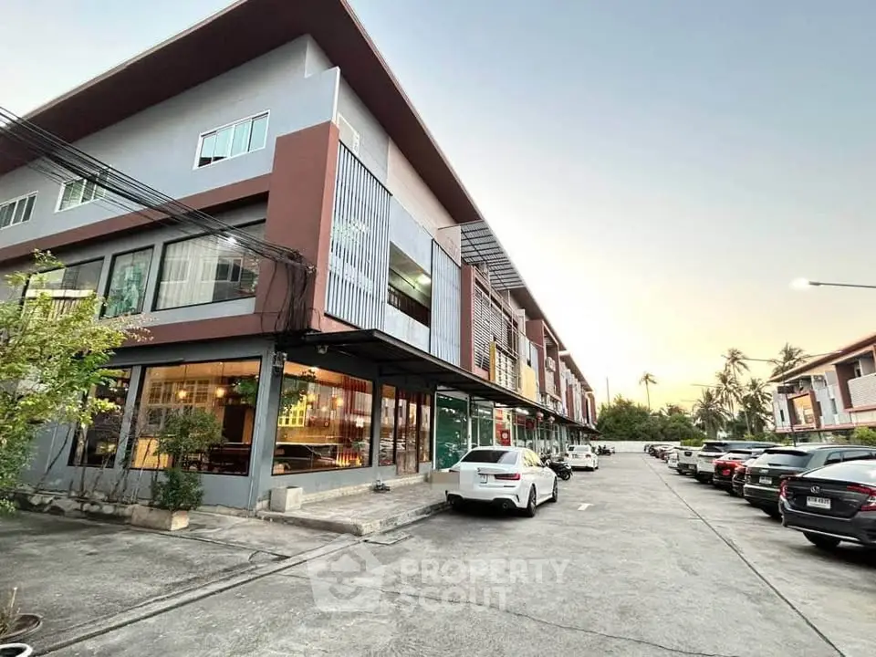 Modern commercial building with ample parking and contemporary design in a bustling area.