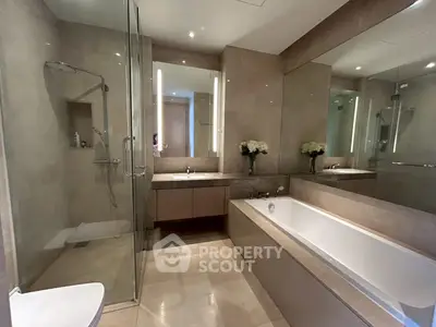 Luxurious modern bathroom with glass shower and elegant bathtub