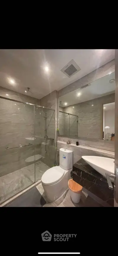 Modern bathroom with glass shower and sleek fixtures