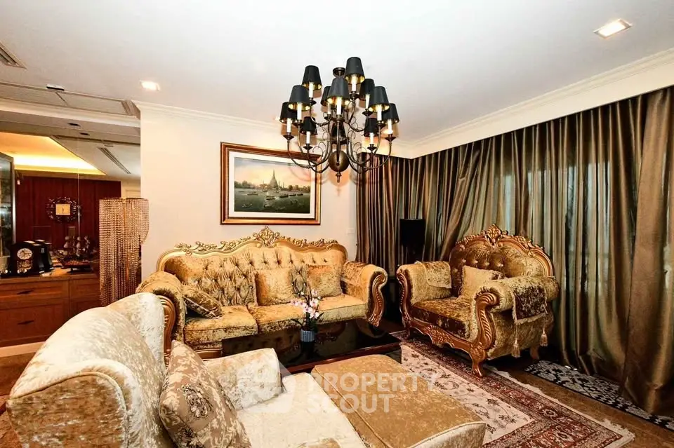 Luxurious living room with elegant chandelier and plush seating in a sophisticated setting.