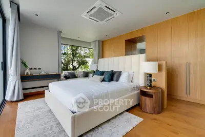 Luxurious modern bedroom with elegant decor and large windows offering natural light.