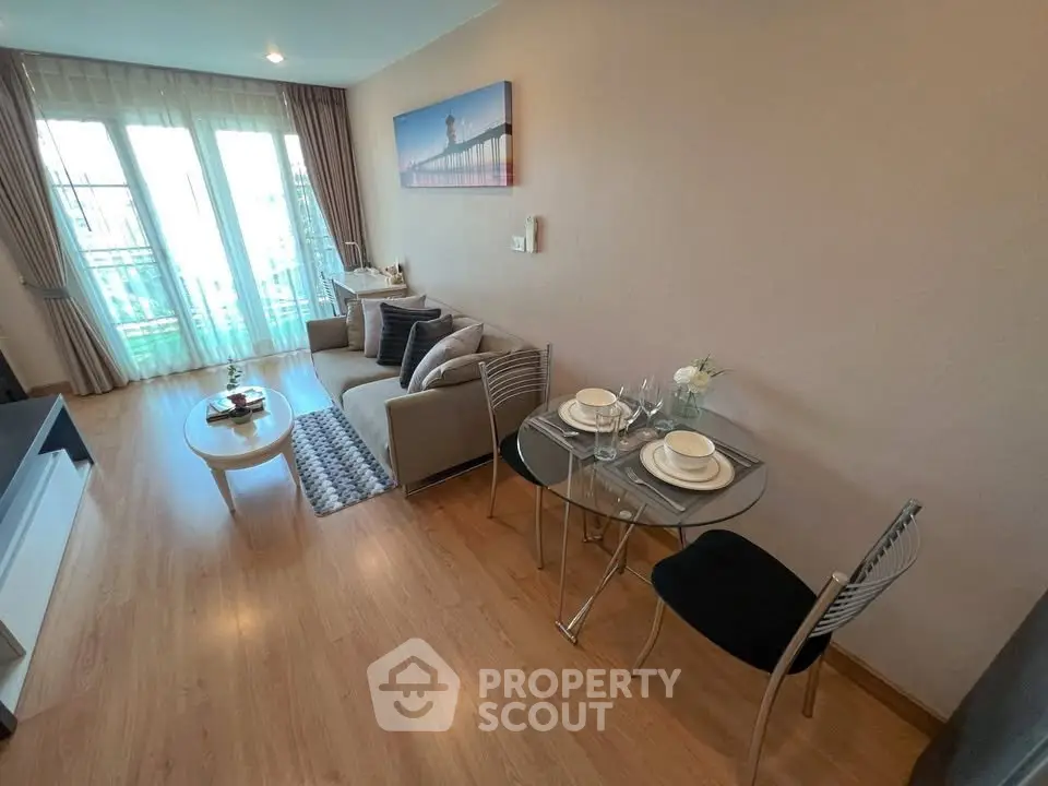 Modern living room with cozy seating and dining area, featuring stylish decor and natural light.