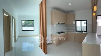 Modern kitchen with open layout and sleek design in a bright, spacious home.