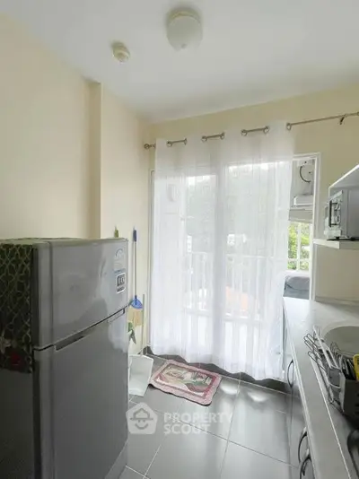 Bright kitchen with modern appliances and balcony access