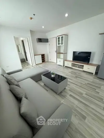 Modern living room with sleek furniture and stylish decor in a contemporary apartment.