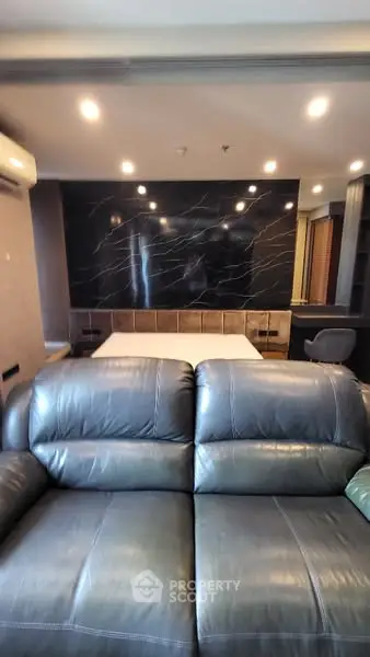 Luxurious living room with leather sofa and modern marble accent wall