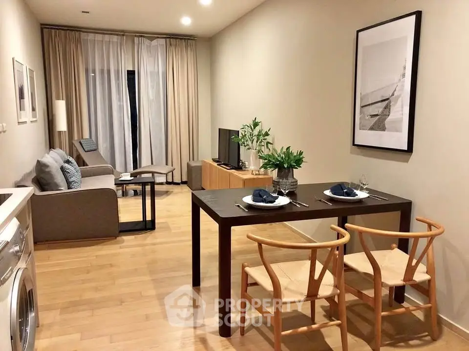 Modern living room with dining area, featuring stylish furniture and natural lighting.