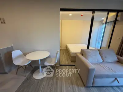 Modern studio apartment with cozy living area and bedroom