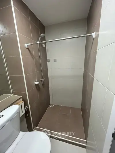 Modern bathroom with sleek shower and neutral tiles