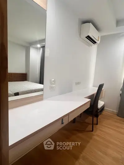 Modern bedroom with sleek desk and air conditioning unit